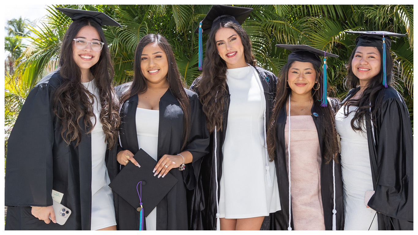 FSW students posing for a photo at a commencement ceremony.
